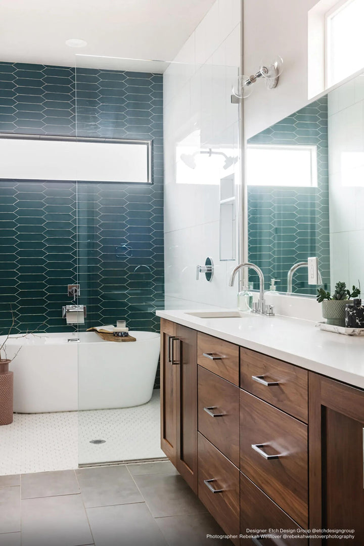 A deep teal matte ceramic tile brings a bold yet elegant statement, adding richness and depth to the space with Reine Dark Teal 3x12 matte glazed ceramic.