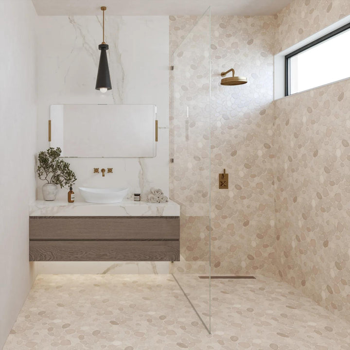 A serene, spa-like aesthetic comes to life with Waterbrook White sliced pebble natural stone mosaic, bringing a refreshing and airy feel to any space.