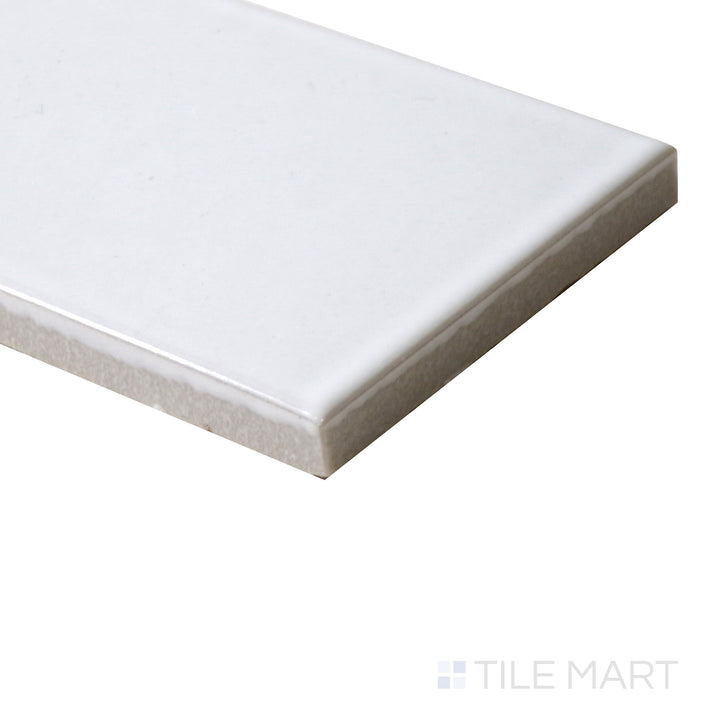 Corner shot of Zenia Milky Way 2.5x9 gloss glazed porcelain tile, featuring a celestial white tone, polished reflective surface, and crisp edge transition.