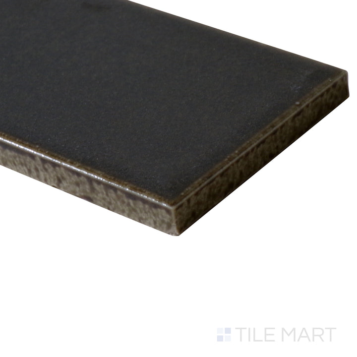 Angled close-up of Zenia Orbit 2.5x9 matte glazed porcelain tile, featuring a deep cosmic blue hue, refined matte finish, and precisely cut edges forming a structured junction.