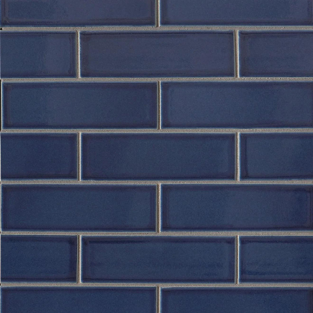 Flat lay of Zenia Tide Rectangle Gloss Glazed Porcelain Mosaic, featuring a fluid blue tone with a high-gloss finish that enhances its oceanic aesthetic.