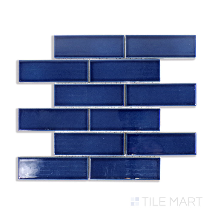 An elegant close-up of Zenia Tide Rectangle Gloss Glazed Porcelain Mosaic captures its deep blue hues and mirror-like gloss, perfect for water-inspired interiors.