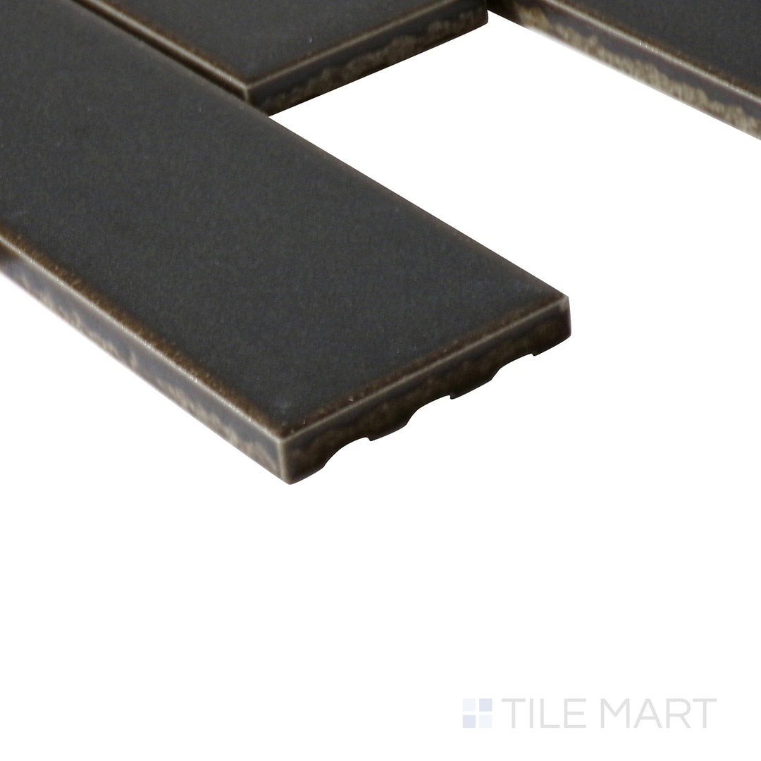 Angled close-up of Zenia Orbit rectangle matte glazed porcelain mosaic, featuring a dark blue shade, structured matte surface, and clean edge formation.