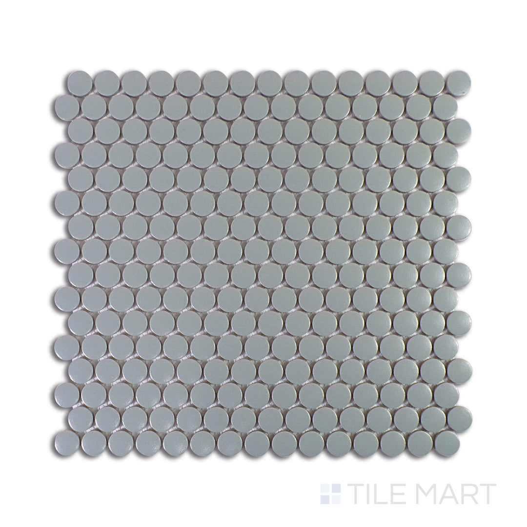 A close-up view of Marin Aloe Green 3/4" Penny Round Matte Glazed Porcelain Mosaic showcases its refreshing green tones and soft matte finish, ideal for a nature-inspired look.