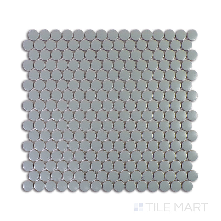 A close-up view of Marin Aloe Green 3/4" Penny Round Matte Glazed Porcelain Mosaic showcases its refreshing green tones and soft matte finish, ideal for a nature-inspired look.