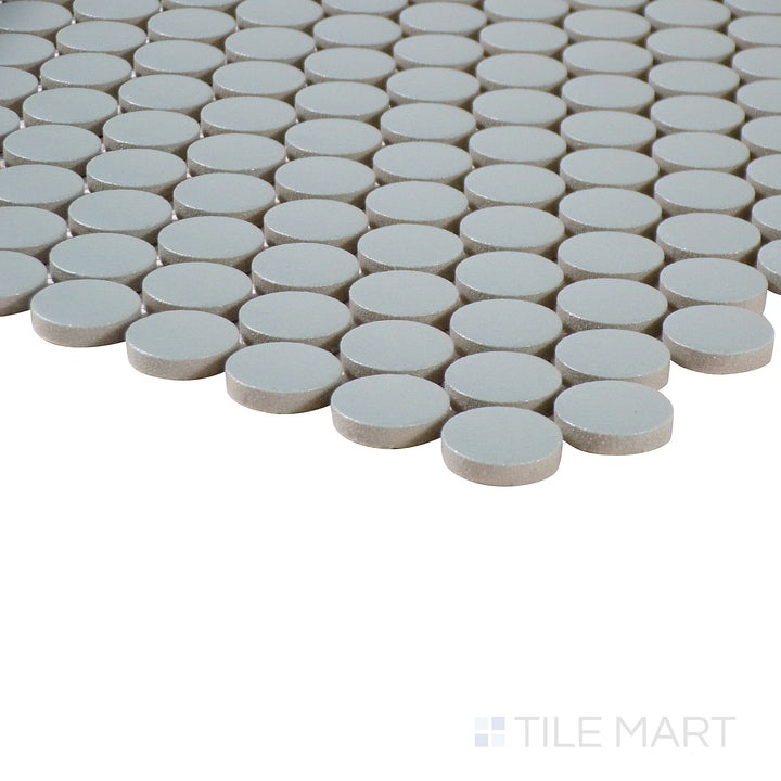 Corner shot of Marin Aloe Green 3/4" penny round matte glazed porcelain mosaic, showcasing its vibrant green hue, soft matte surface, and seamless penny tile arrangement.