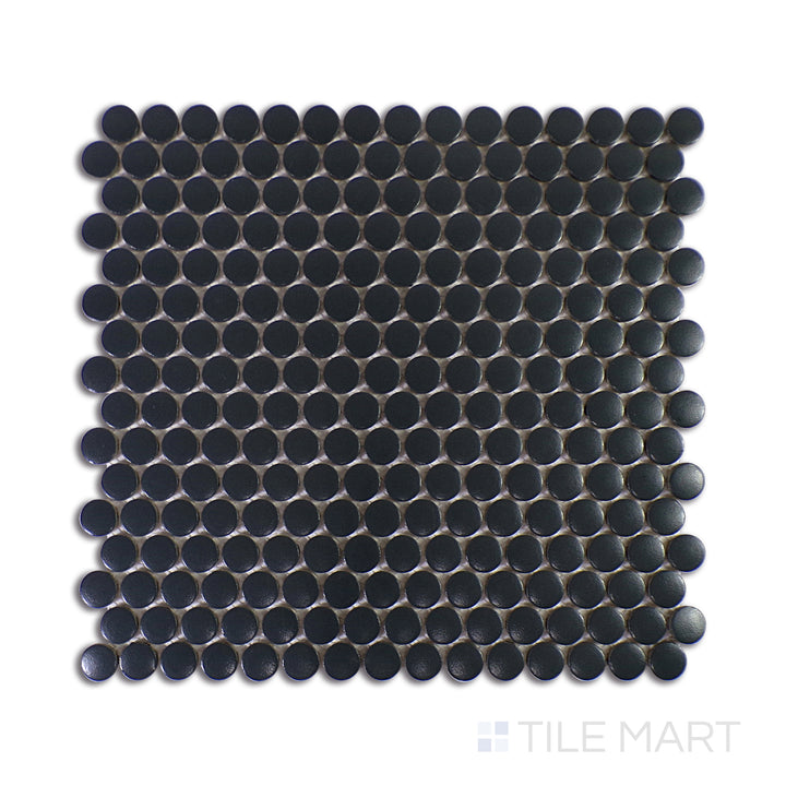 A detailed close-up shot of Marin Black Sea 3/4" Penny Round Matte Glazed Porcelain Mosaic highlights its deep black hues and velvety matte texture, exuding modern sophistication.