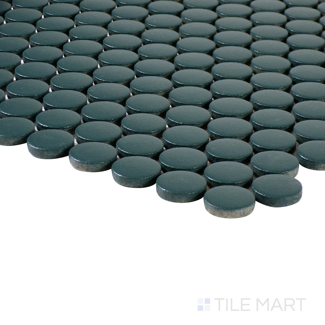 Corner shot of Marin Ocean Teal 3/4" penny round matte glazed porcelain mosaic, displaying its rich teal color, non-reflective matte finish, and seamless transition of tiles.