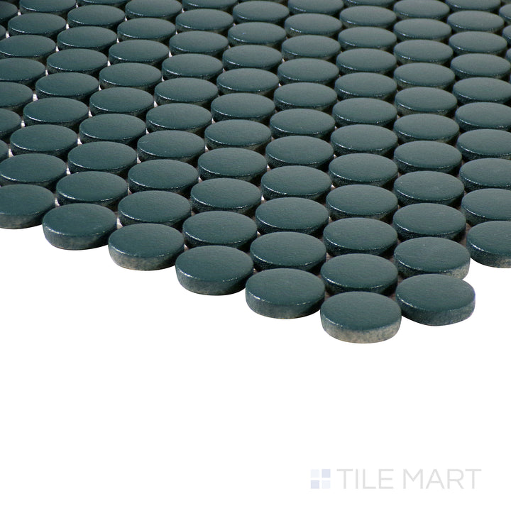 Corner shot of Marin Ocean Teal 3/4" penny round matte glazed porcelain mosaic, displaying its rich teal color, non-reflective matte finish, and seamless transition of tiles.