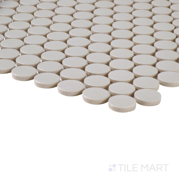 Side-angle close-up of Marin Pebble Gray 3/4" penny round matte glazed porcelain mosaic, highlighting its neutral gray shade, matte texture, and precise penny tile placement.