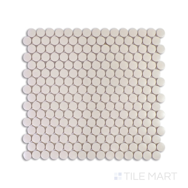 A focused macro shot of Marin Sand Dollar 3/4" Penny Round Matte Glazed Porcelain Mosaic highlights its warm beige tones and soft matte texture, evoking the tranquility of coastal sands.