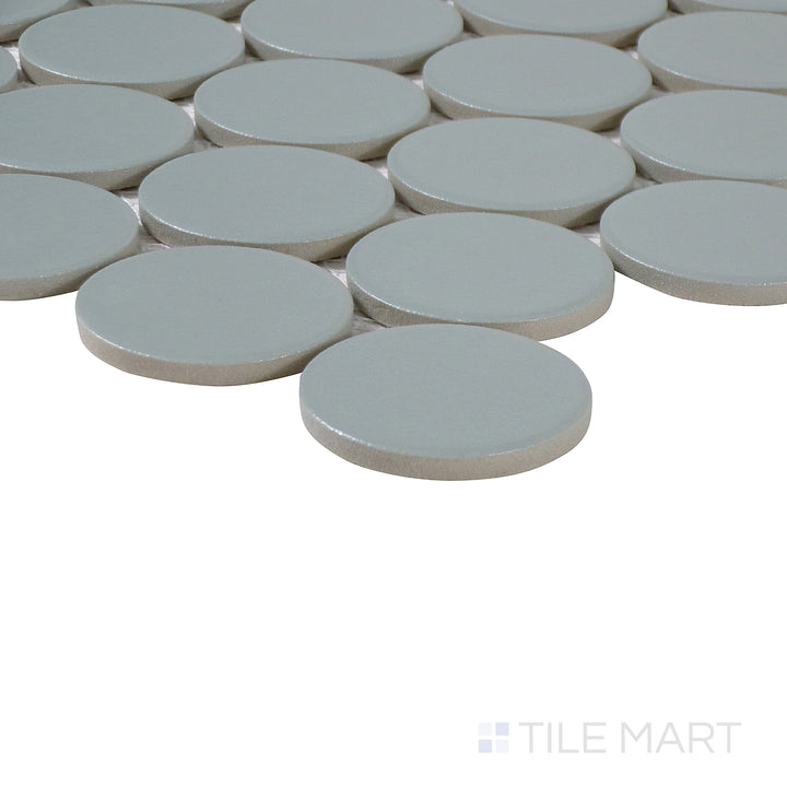Corner shot of Marin Aloe Green 2" penny round matte glazed porcelain mosaic, showcasing its refreshing green tone, smooth matte finish, and the precision in tile alignment.