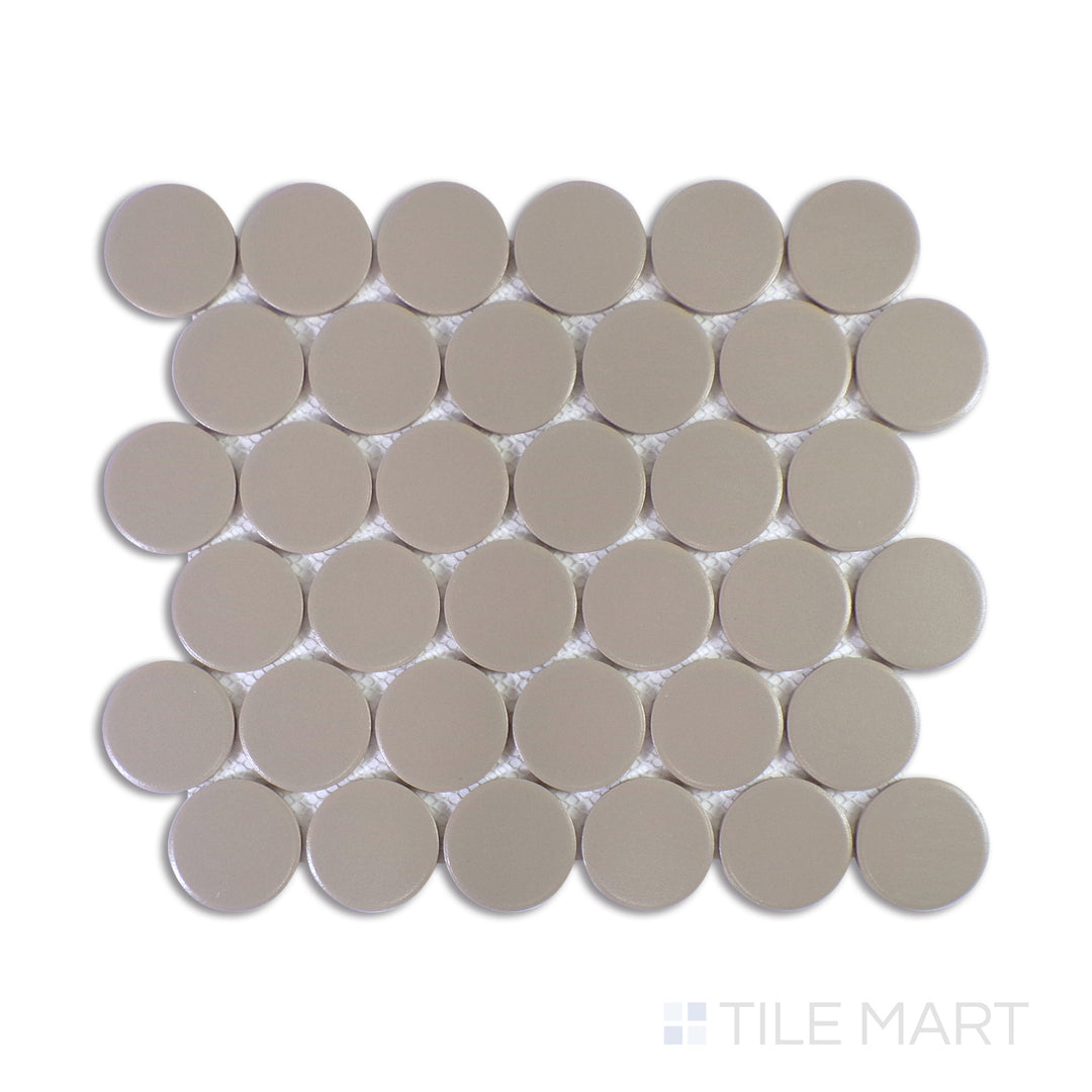 A detailed close-up of Marin Coastal Cliff 2" Penny Round Matte Glazed Porcelain Mosaic highlights its balanced mix of soft greys with a matte texture, bringing an earthy, contemporary feel.