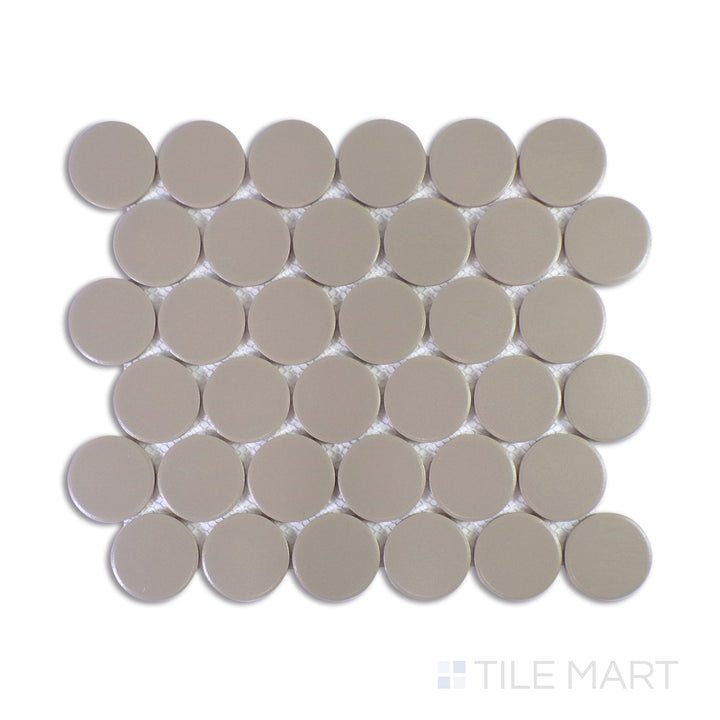 A detailed close-up of Marin Coastal Cliff 2" Penny Round Matte Glazed Porcelain Mosaic highlights its balanced mix of soft greys with a matte texture, bringing an earthy, contemporary feel.