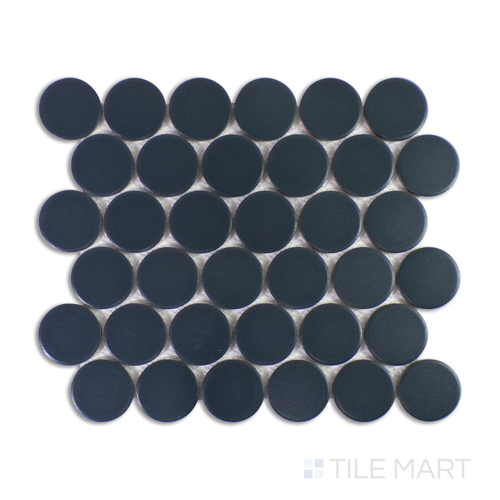 A finely tuned close-up shot of Marin Midnight Tide 2" Penny Round Matte Glazed Porcelain Mosaic reveals its dramatic deep blue hues and smooth matte glaze, embodying oceanic elegance.