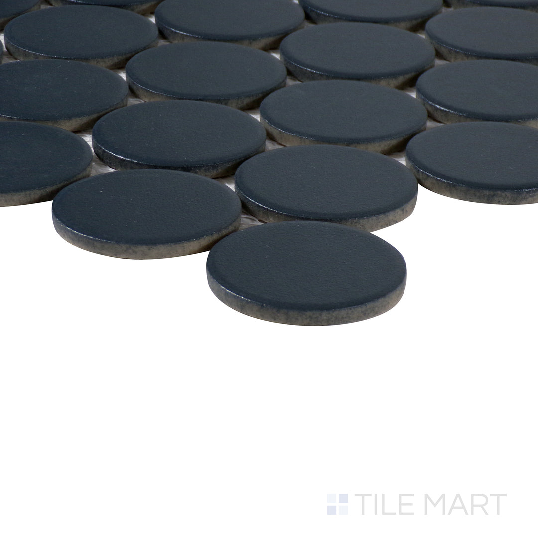 Corner-focused image of Marin Midnight Tide 2" penny round matte glazed porcelain mosaic, emphasizing its deep navy blue color, matte surface, and the smooth intersection of tiles at the edge.