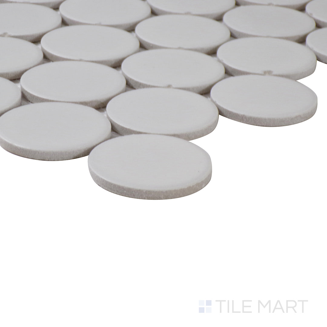 Corner shot of Marin Pearl White 2" penny round matte glazed porcelain mosaic, showcasing its bright white hue, uniform circular tile pattern, and seamless corner alignment.