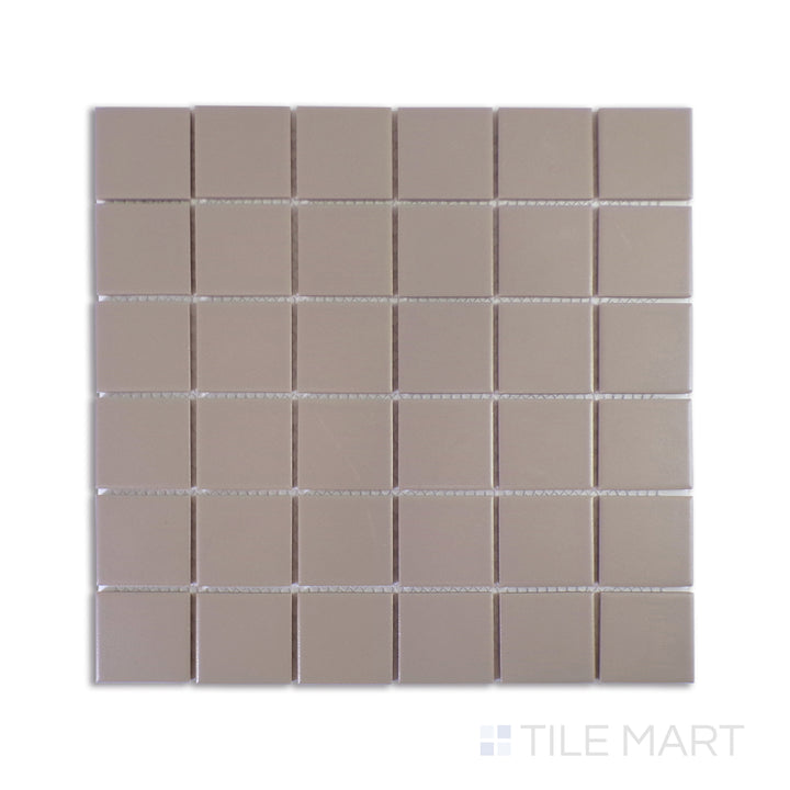 A precise close-up of Marin Coastal Cliff 2" Square Matte Glazed Porcelain Mosaic showcases its soft gray tones and refined matte texture, offering timeless coastal elegance.