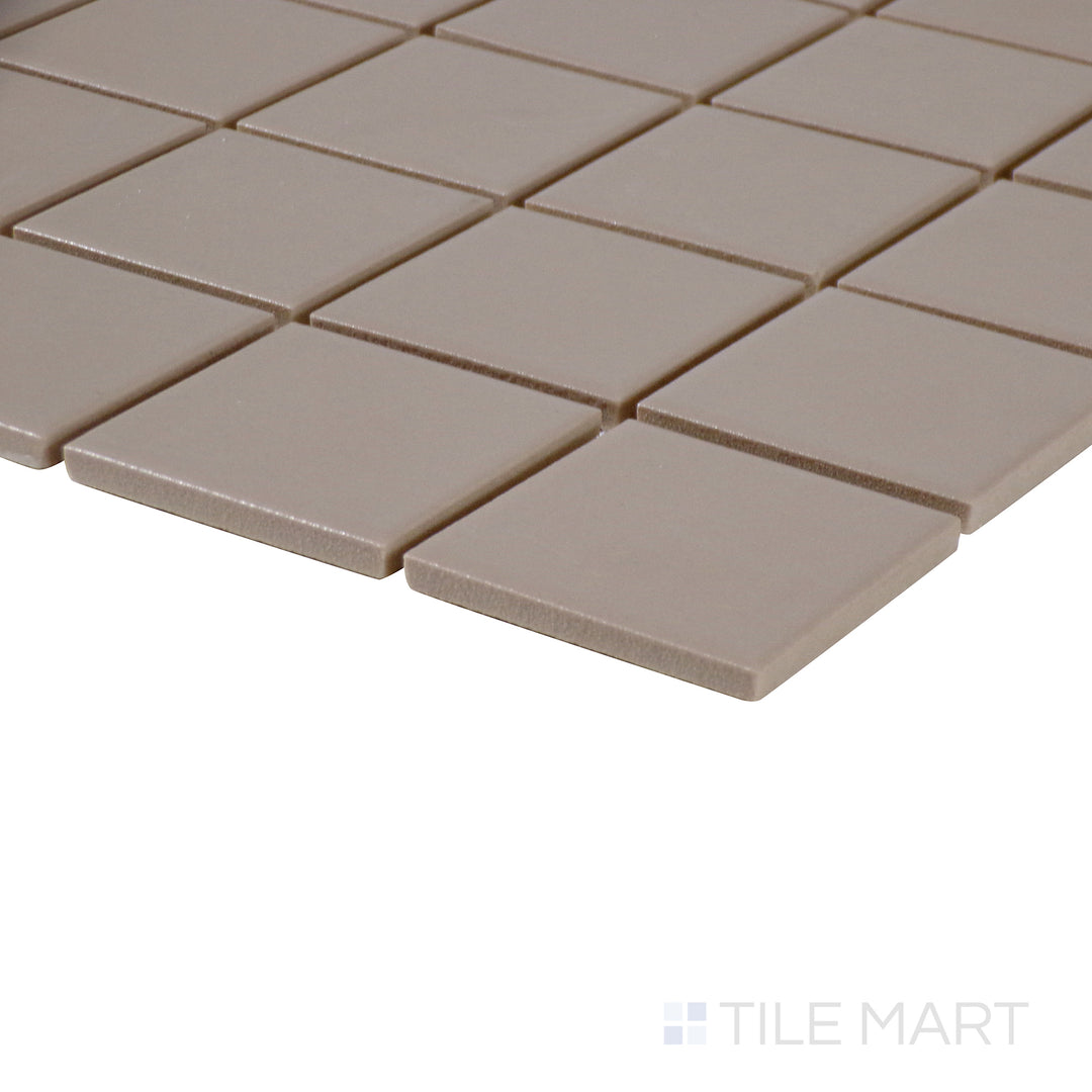Corner-focused image of Marin Coastal Cliff 2" square matte glazed porcelain mosaic, emphasizing its neutral sandy hue, soft matte surface, and well-defined intersection at the corner.