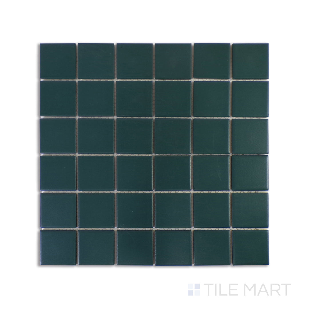 A sharply focused close-up of Marin Ocean Teal 2" Square Matte Glazed Porcelain Mosaic showcases its rich teal shade and matte finish, bringing depth and vibrancy to any design.
