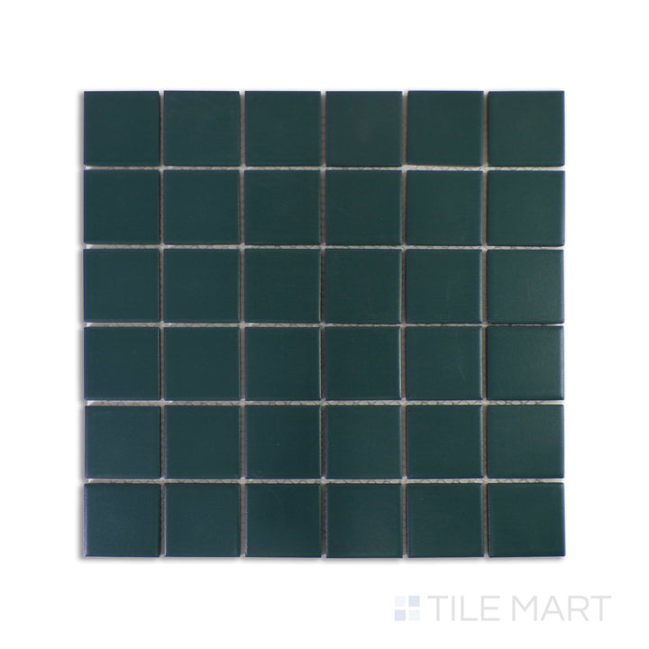 A sharply focused close-up of Marin Ocean Teal 2" Square Matte Glazed Porcelain Mosaic showcases its rich teal shade and matte finish, bringing depth and vibrancy to any design.