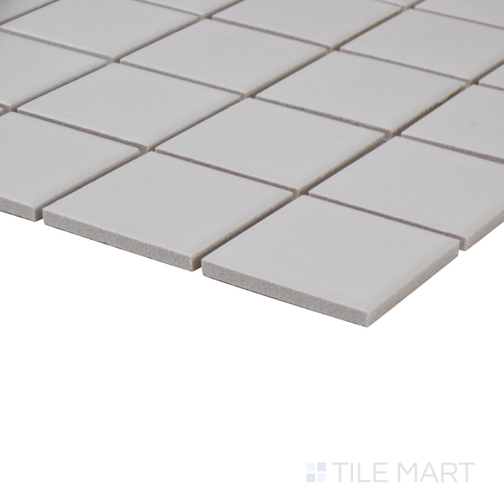 Corner-focused image of Marin Pearl White 2" square matte glazed porcelain mosaic, drawing attention to its bright white shade, even matte finish, and crisp edge alignment.