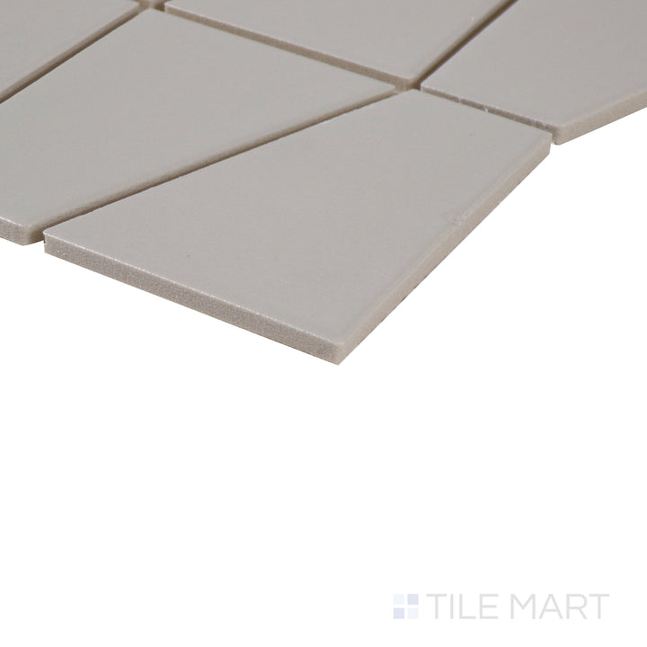 Corner shot of Marin Pebble Gray trapezoid matte glazed porcelain mosaic, displaying its neutral gray tone, soft matte finish, and seamlessly aligned edges at the intersection.