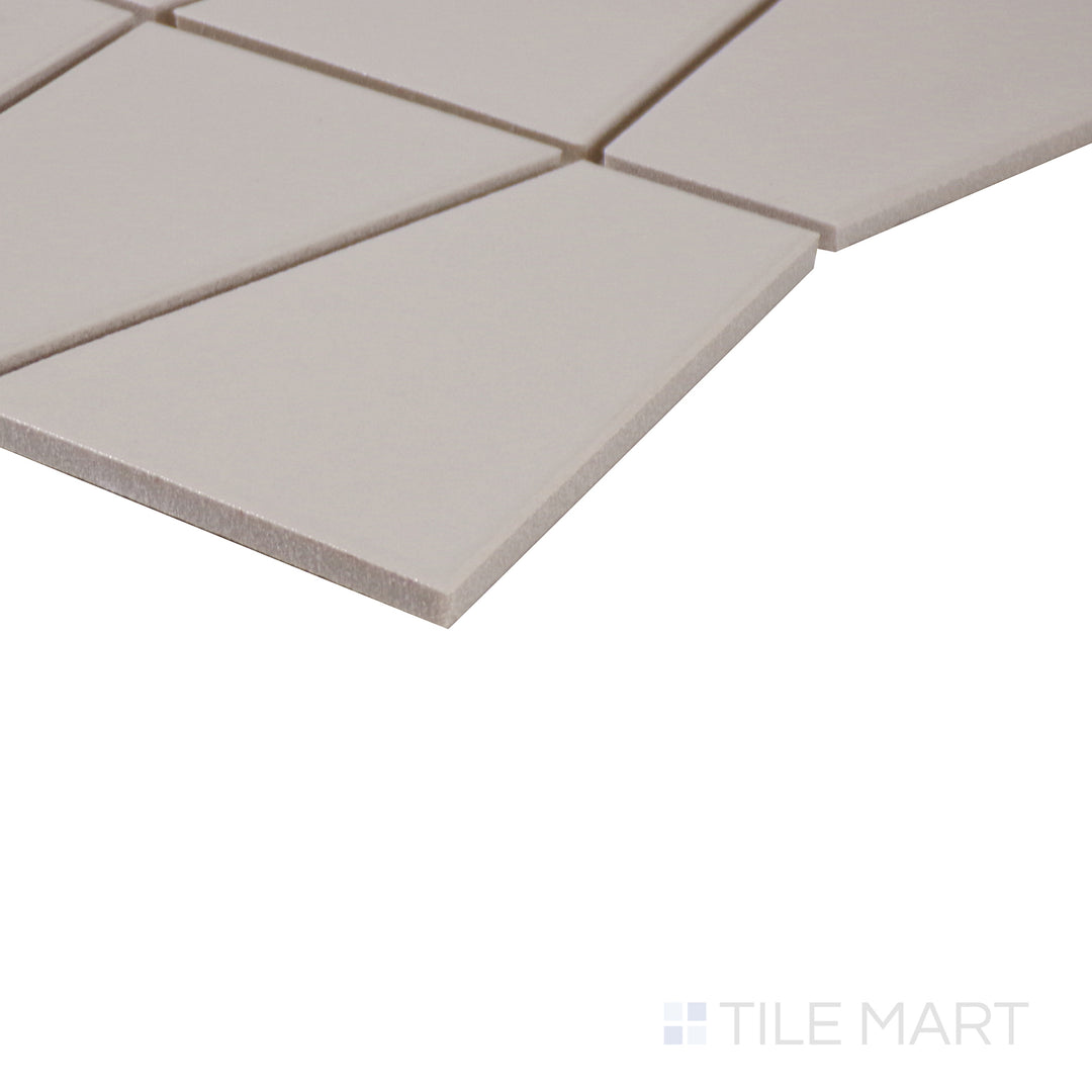 Angled perspective of Marin Sand Dollar trapezoid matte glazed porcelain mosaic, showcasing its warm beige hue, non-glossy texture, and the precise alignment of the corner edges.