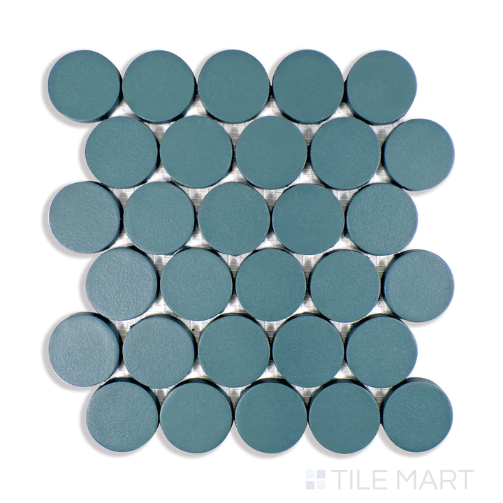 A close-up perspective of Makoto Arashi Blue 2" Round Matte Porcelain Mosaic captures its deep blue color and velvety matte finish, perfect for creating a bold yet sophisticated accent.