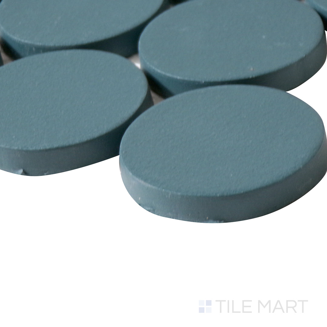 Angled perspective of Makoto Arashi Blue 2" round matte porcelain mosaic, showcasing its rich blue hue, non-glossy texture, and seamless transition at the corner intersection.