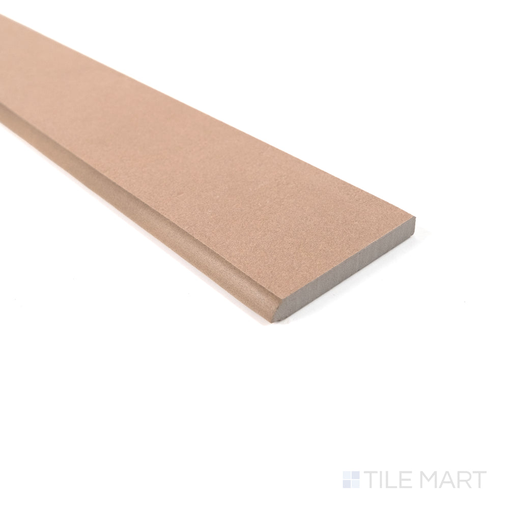 Detailed view of Sahara Rose matte porcelain bullnose tile highlighting its soft blush hue and rounded edge.