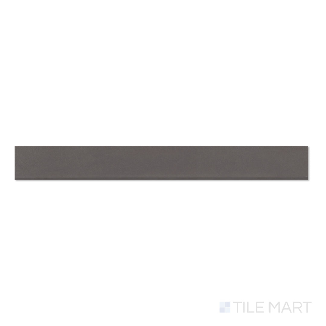 Flat lay of Sahara Dark 3x24 matte porcelain bullnose tile, emphasizing deep charcoal coloring and a polished bullnose edge.