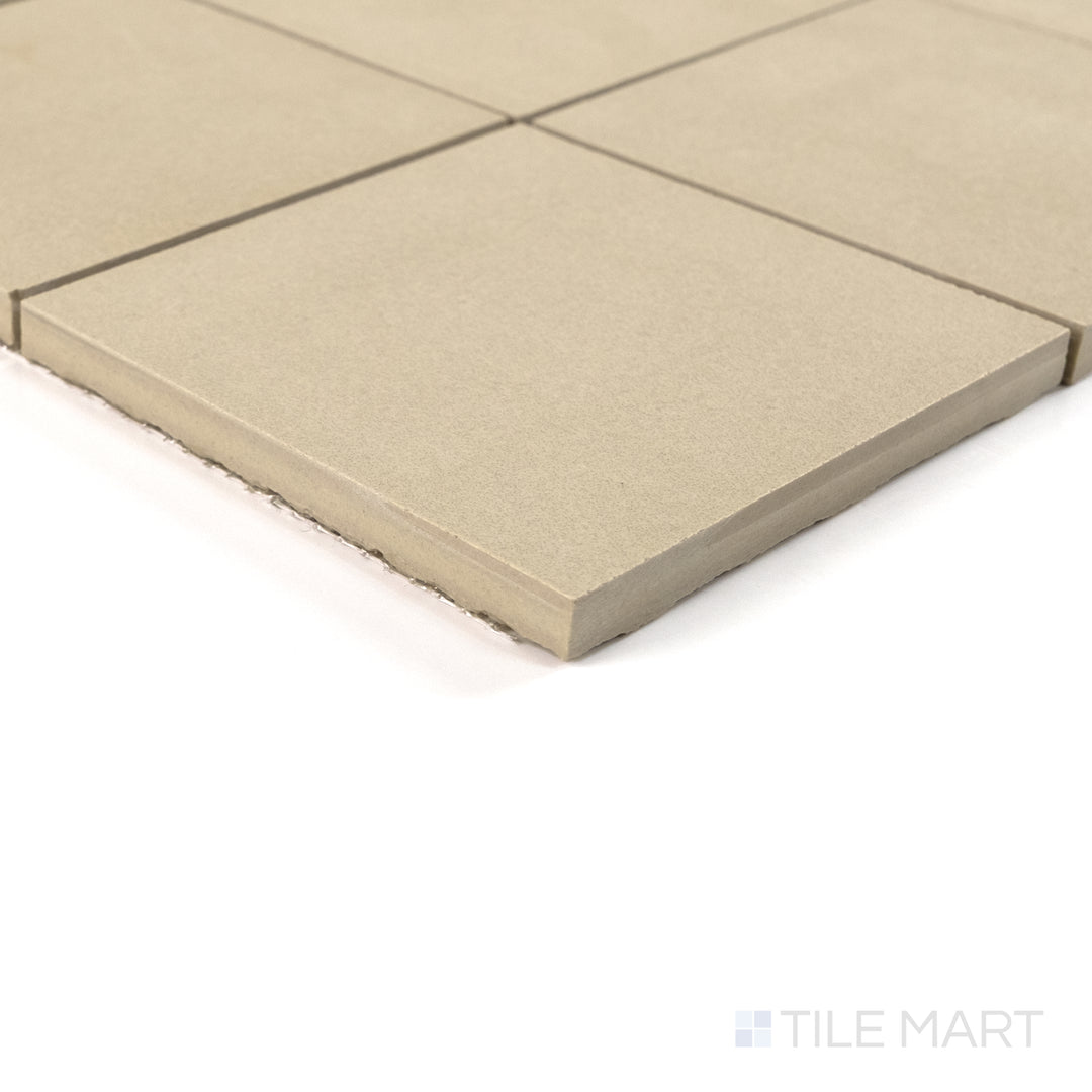 Corner view of Sahara Ecru 4" square matte porcelain mosaic capturing its creamy tone and soft textured surface.
