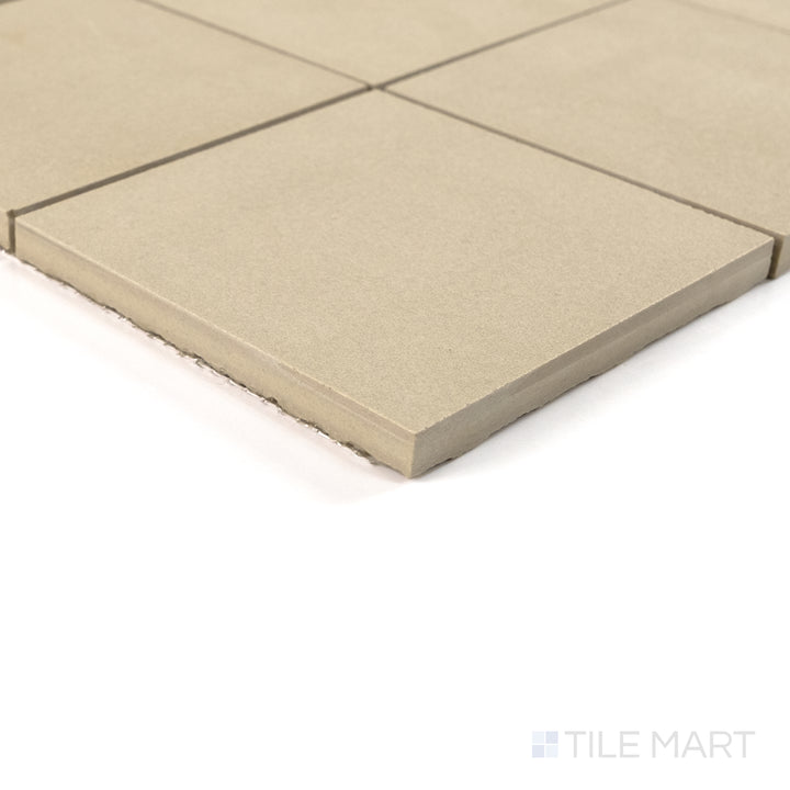 Corner view of Sahara Ecru 4" square matte porcelain mosaic capturing its creamy tone and soft textured surface.
