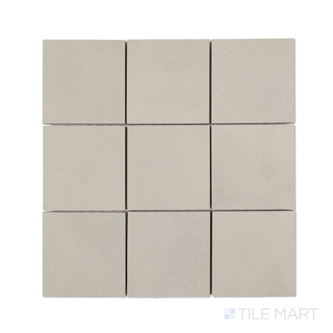 Flat-lay of Sahara Grey 4-inch square matte porcelain mosaic, with cool grey tiles organized in a balanced square grid.
