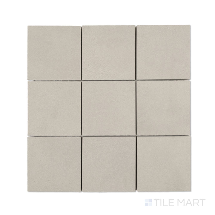 Flat-lay of Sahara Grey 4-inch square matte porcelain mosaic, with cool grey tiles organized in a balanced square grid.
