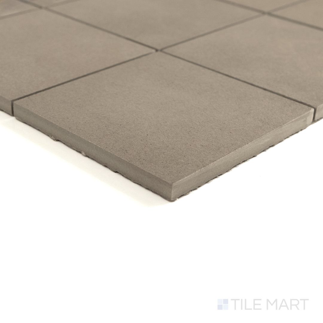 Corner view of Sahara Taupe 4" square matte porcelain mosaic showcasing its warm undertone and fine matte finish.