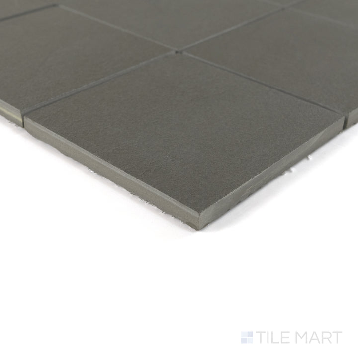 Corner close-up of Sahara Dark 4" square matte porcelain mosaic emphasizing its deep tone and sleek textured edge.