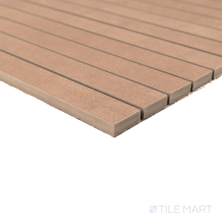 Corner detail of Sahara Cotto 1x12 matte porcelain mosaic showing its earthy tone and smooth elongated edge.