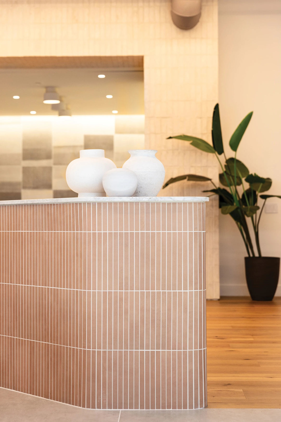 Featuring soft rose hues, Sahara Rose 1x12 matte porcelain mosaic creates subtle color variation with linear texture.