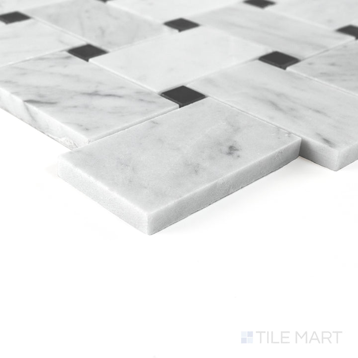 Corner detail of Jumbo Basketweave White Carrara with Absolute Black dot honed marble mosaic highlighting contrast.