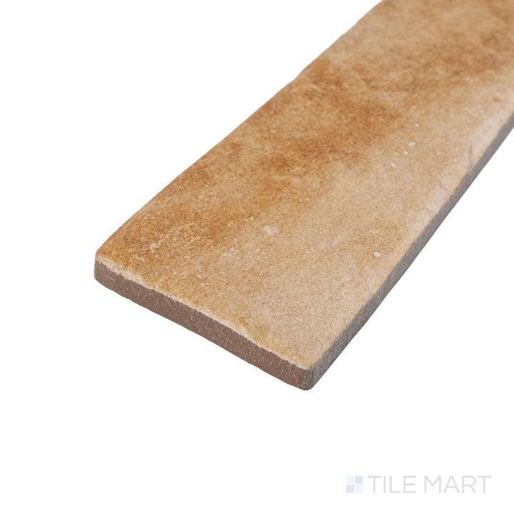 Corner detail of Montana Yellowstone 2.5x10 matte porcelain tile with warm tones and clean linear edges
