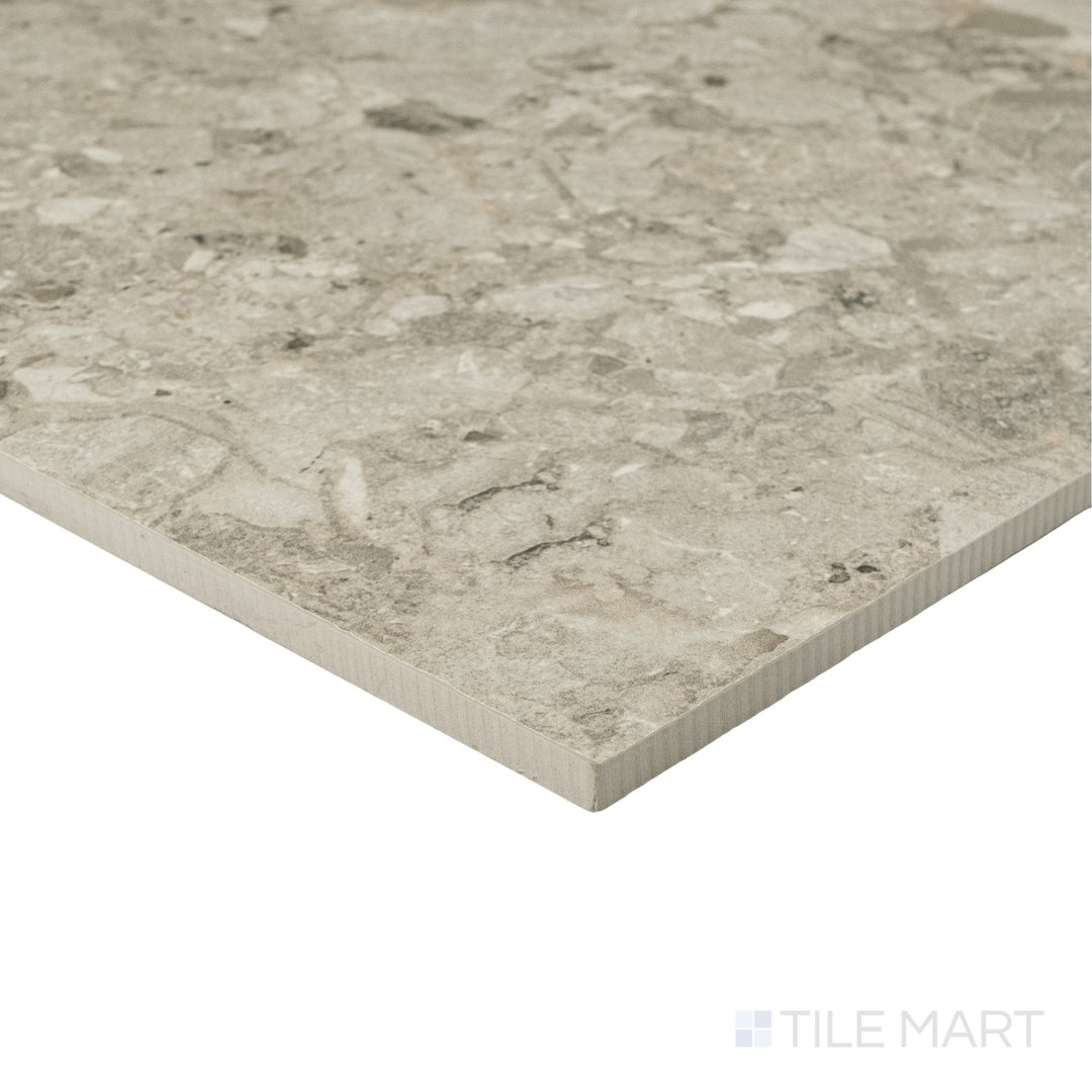 Frammenta Beige 24x24 matte porcelain tile shown at corner angle with warm aggregate detail and smooth surface