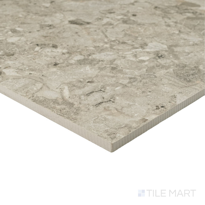 Frammenta Beige 24x24 matte porcelain tile shown at corner angle with warm aggregate detail and smooth surface