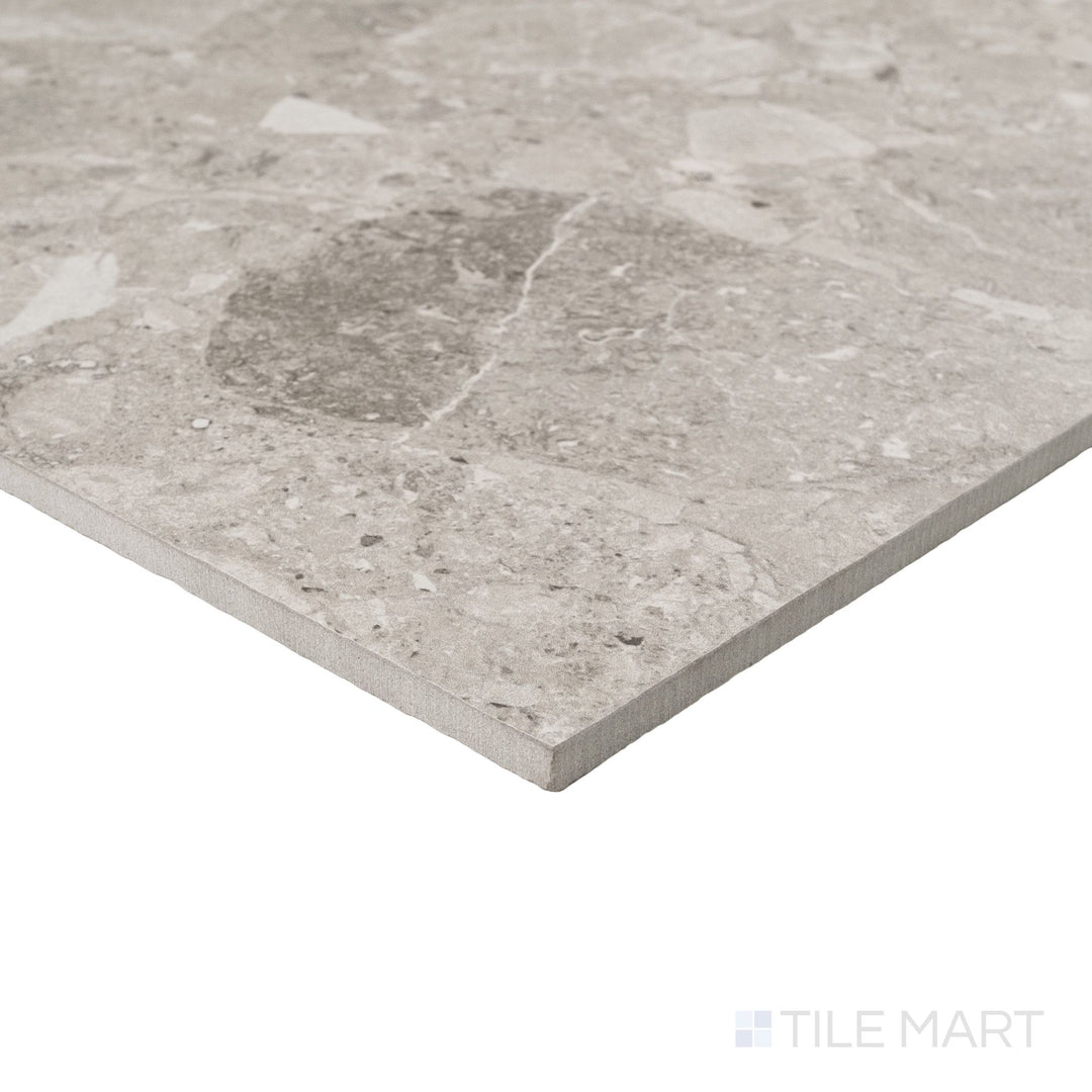 Corner detail of Frammenta Light Grey 24x24 matte porcelain tile revealing subtle tonal movement