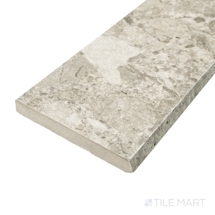 Frammenta Beige 3x24 matte porcelain bullnose shown in corner view with smooth curved edge