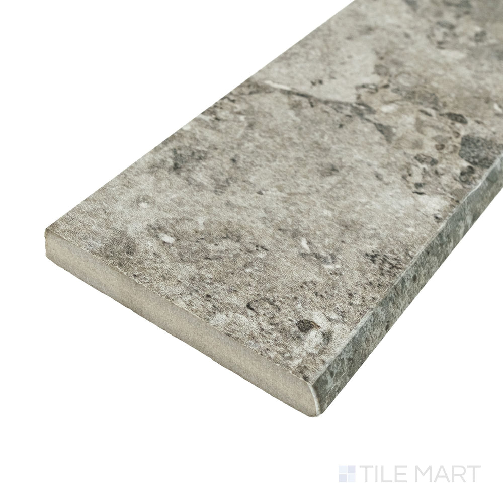 Corner view of Frammenta Dark Grey 3x24 matte porcelain bullnose highlighting rounded trim profile and clean edge