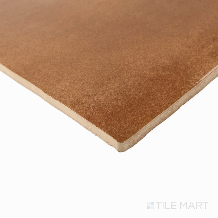 Corner detail of Cotto Nature Sicilia 14x14 gloss porcelain tile highlighting its glazed surface and warm natural color.