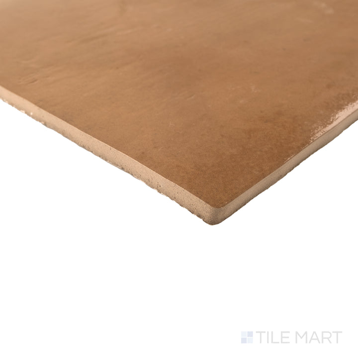 Corner view of Cotto Nature Siena 14x14 gloss porcelain tile capturing subtle variation and polished edge detail.