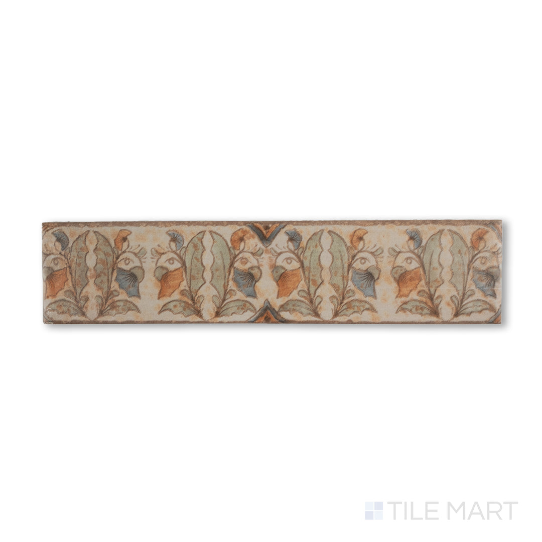 Top-down shot of Cotto Nature Tira Versilia 3x14 gloss porcelain liner, showcasing hand-painted scrolling patterns with a refined, glossy surface.